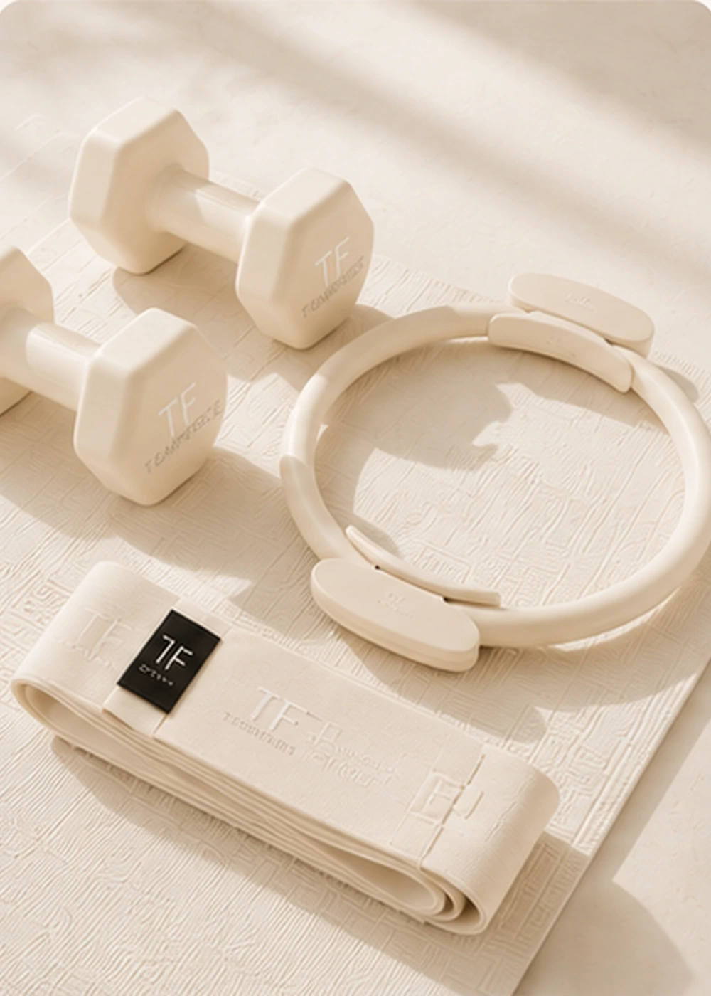 Premium fitness equipment samples arranged with mats, rings, dumbbells and product development tools.